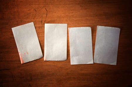 Handwritten paper reminder note over a wooden backgroundの写真素材
