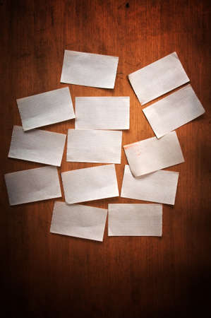 Handwritten paper reminder note over a wooden backgroundの写真素材