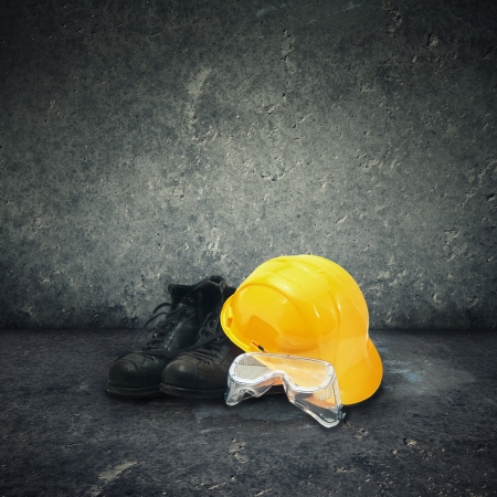 Protective equipment in obsolete gray grunge concrete roomの写真素材