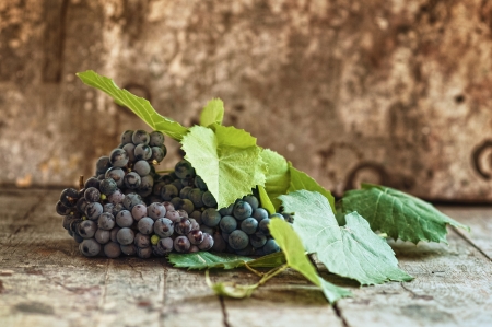 Fresh tasty ripe grapes on an old wooden tableの写真素材