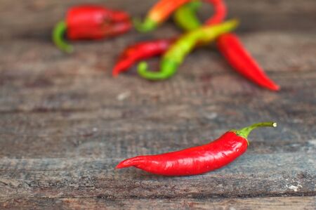 Red hot chili pepper on an obsolete wooden background textureの写真素材