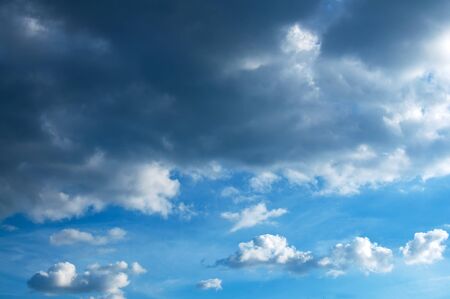 Beautiful fluffy white clouds in blue summer sky. This cloudscape image is suitable as a background...