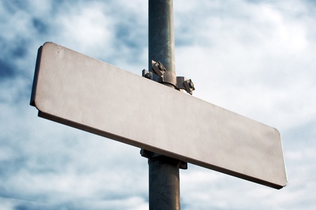 Emprty street sign on metal post, cloudy sky in the background の写真素材