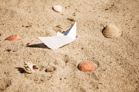 paper boat sailing on blue water surfaceの写真素材
