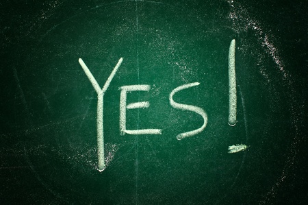 Yes concept; word written with chalk on the green boardの写真素材