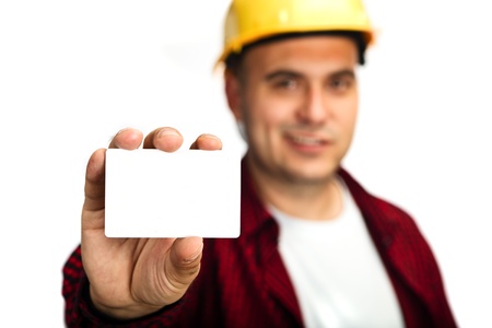 Construction worker holding a blank business card, business introduction concept.の写真素材