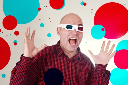 Portrait of a sscared man with anaglyph glasses watching a 3d movie 