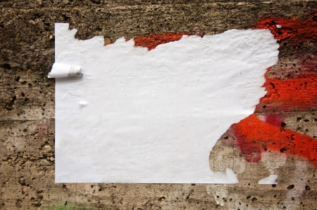 Blank torn paper poster on an old brick wallの写真素材