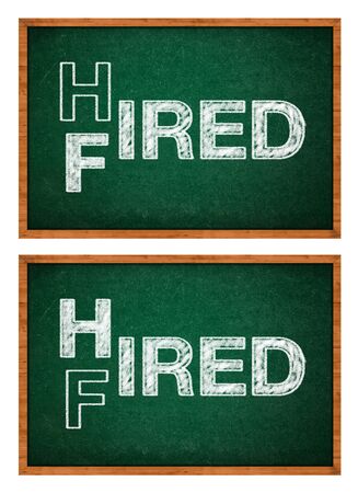 Hired or fired concept, two words handwritten on a chalkboard.の写真素材