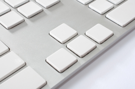 Close up image of a modern stylish aluminium white computer keyboard with blank keys for your own...