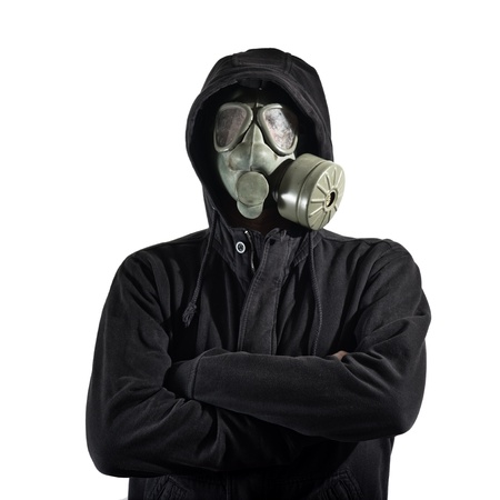 Man in dark clothes wearing a classic gas mask respirator over a white background の写真素材