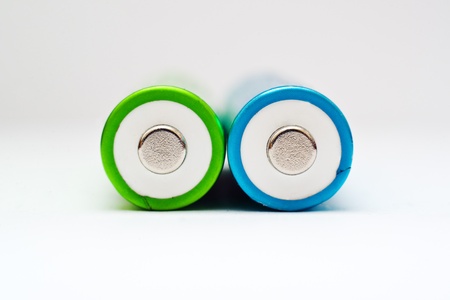 AA bateeries. Green and blue AA batteries close up.の写真素材
