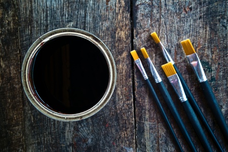 Paint brushes and paint can on old wood background.の写真素材