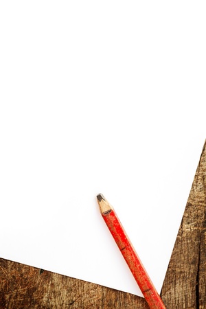 Old lead pencil and white blank paper on wood background.の写真素材