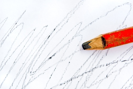 Old lead pencil and white blank paper with scribblesの写真素材