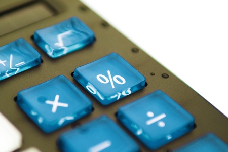 Blue percent key on plastic calculator, close up with shllow depth of field.