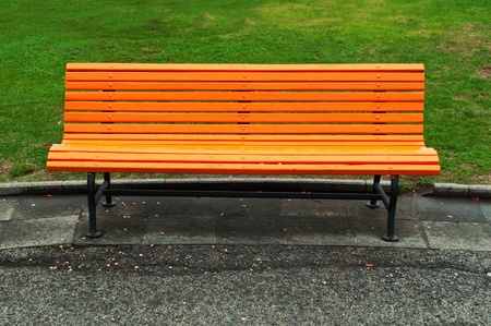 Orange park bench on a cloudy rainy day