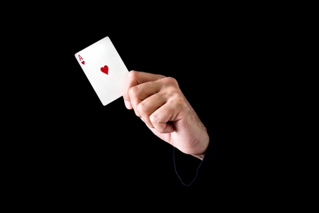 Hand holding ace of hearts card on black backgroundの写真素材