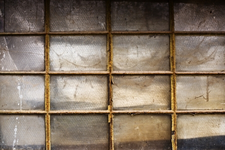 Old metal shed window with dirty obsolete glass.