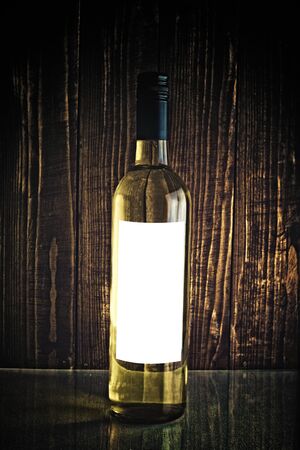 White wine in bottle on dark backgroundの写真素材