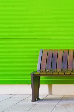Stylish bench against green wall as backgroundの写真素材