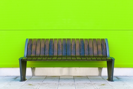 Stylish bench against green wall as backgroundの写真素材