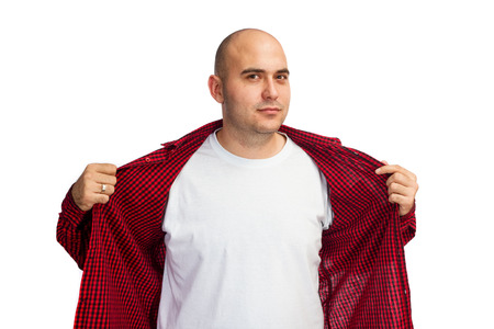 Man opening his red shirt to show his white T-shirt under itの写真素材
