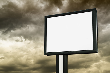 Blank Billboard with empty screen over dark syormy cloudsの写真素材