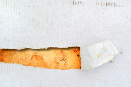 Torn dirty cardboard paper as a background for your title or design の写真素材