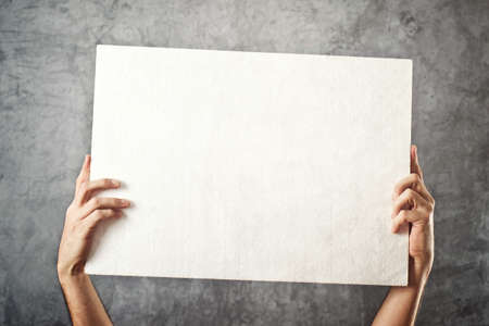 Man holding blank white banner with copy space for your text.の写真素材