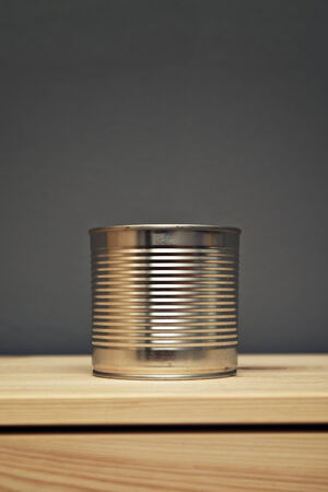 Metal tin can on wooden table with copy space
