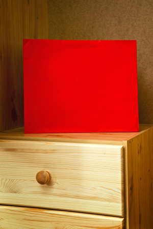 Red shopping bag in wooden beech cabinet の写真素材