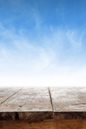 Empty table against blue sky as background for product placementの写真素材