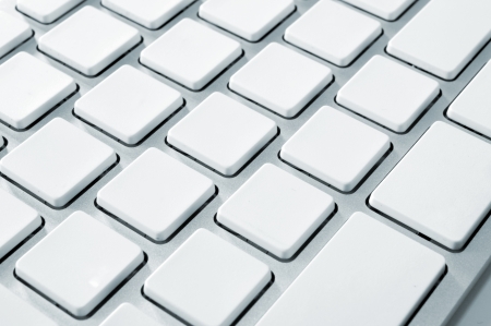 Close up image of a modern stylish aluminium white computer keyboard with blank keys for your own idea の写真素材
