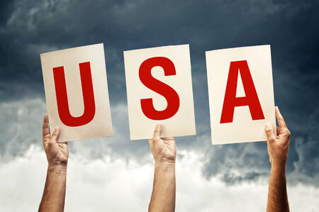 Hands holding papers with letters forming American country code USAの写真素材