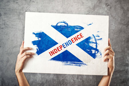 Man holding banner with Scottish independence Flagの写真素材
