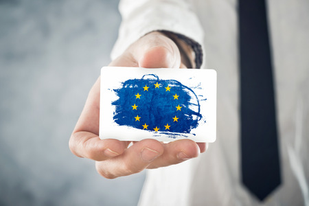 European Businessman holding business card with European union Flag  International cooperation,...