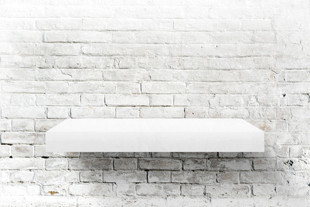 White brick wall and shelf as background for product placement.の写真素材