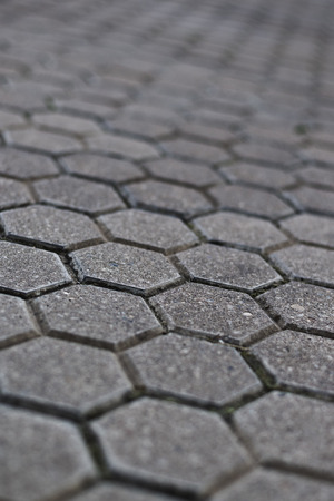 Cobblestone pavement with selective focus and shallow depth of field. Urban street background.の写真素材