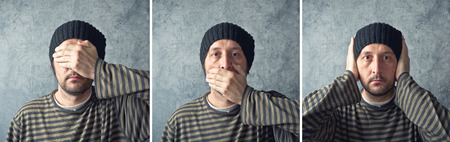 Man closing his eyes, mouth and ears. See nov evil, speak no evil, hear no evil triptych.の写真素材