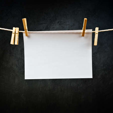 Blank note paper hanging on rope with clothes pins, copy space for your text or image or product...