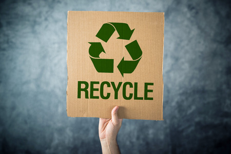 RECYCLE  Man holding cardboard with Recycle symbol printed, environment preservation activist 