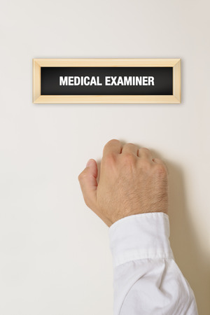Male patient knocking on Medical Examiner door for a medical exam.の写真素材