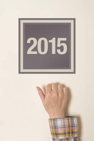 Woman knocking on door with number 2015