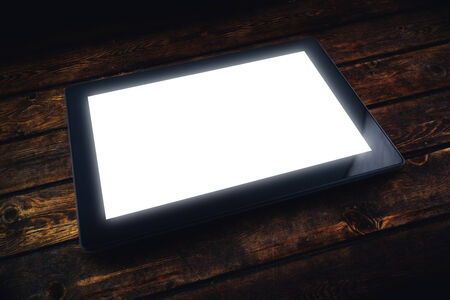 Generic model of Tablet PC on table. 10 inch display tablet computer as modern technology high tech gadget in media era.の写真素材