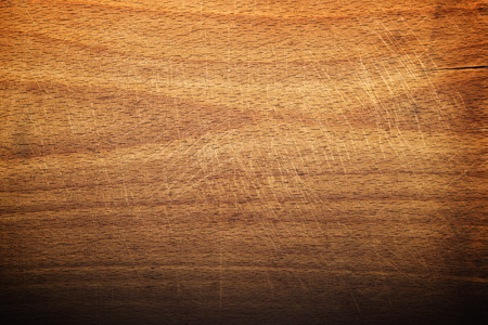 Worn butcher block cutting and chopping wooden board as background. Wood texture.