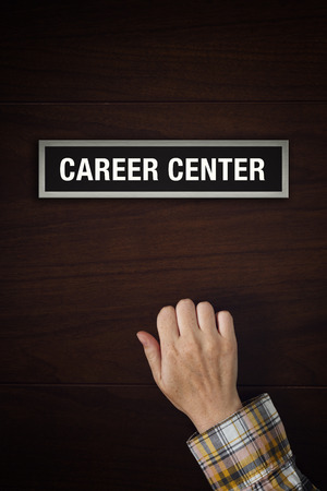 Hand is knocking on Career Center door, conceptual image.の写真素材