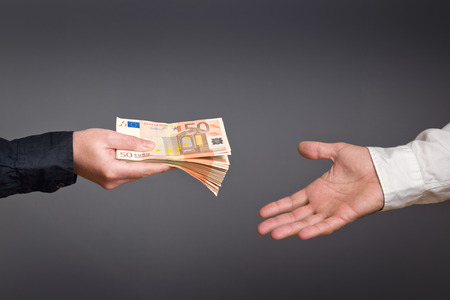 Money Loan. Bank officer loaning stack of euro banknotes money.の写真素材