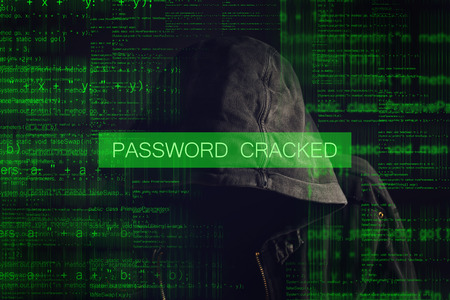 Password Cracked by Faceless hooded anonymous computer hacker with programming code from monitorの写真素材