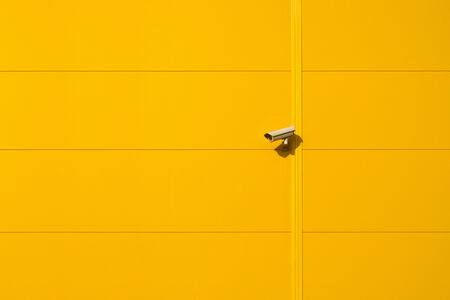 Security cctv camera mounted on the wall of industrial building as Big Brother conceptの写真素材